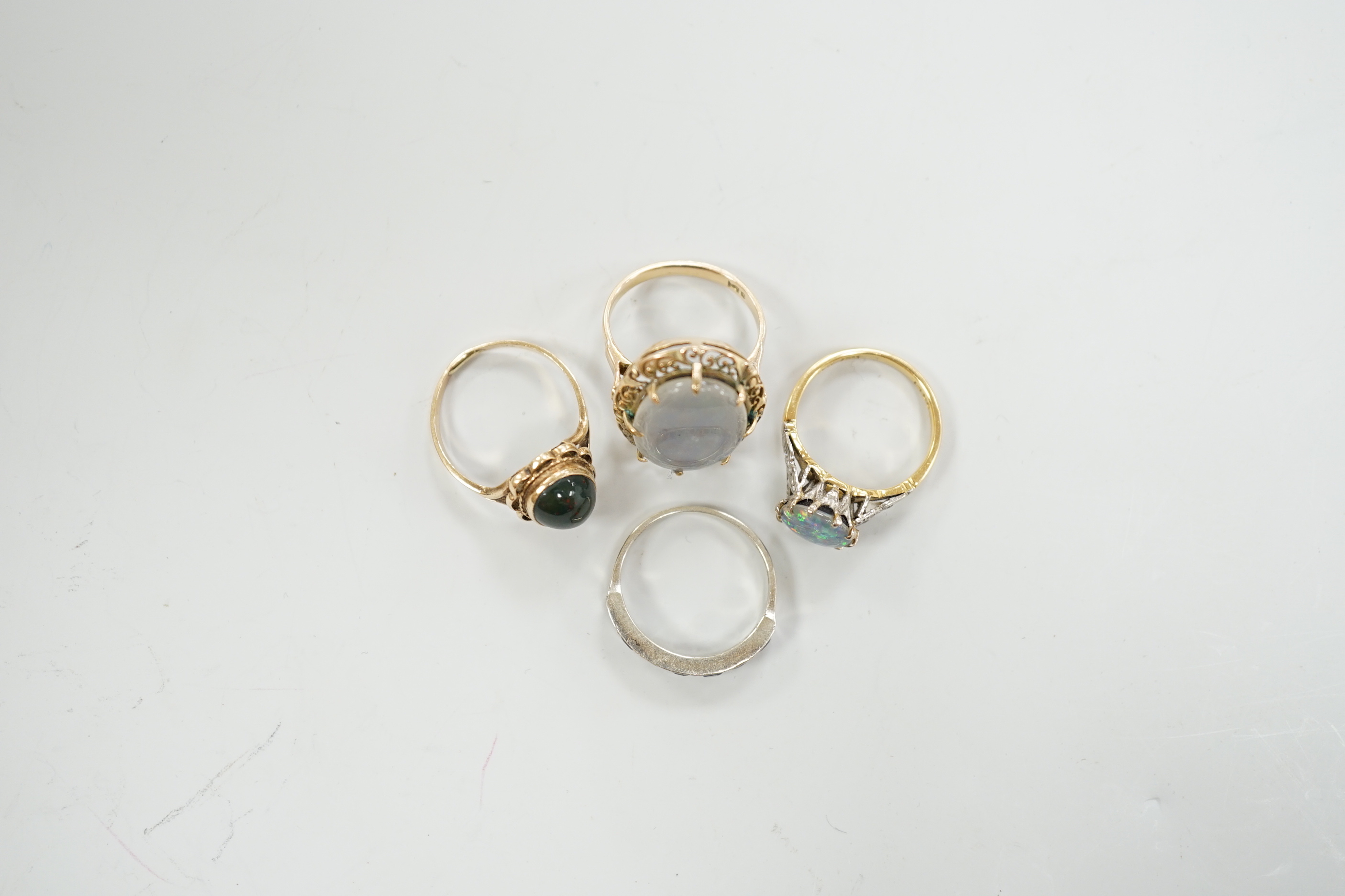 A 1940's 18ct and black opal doublet set dress ring, with diamond chip set shoulders, size L, a 14c and oval doublet ring and two other 9ct and gem set rings.